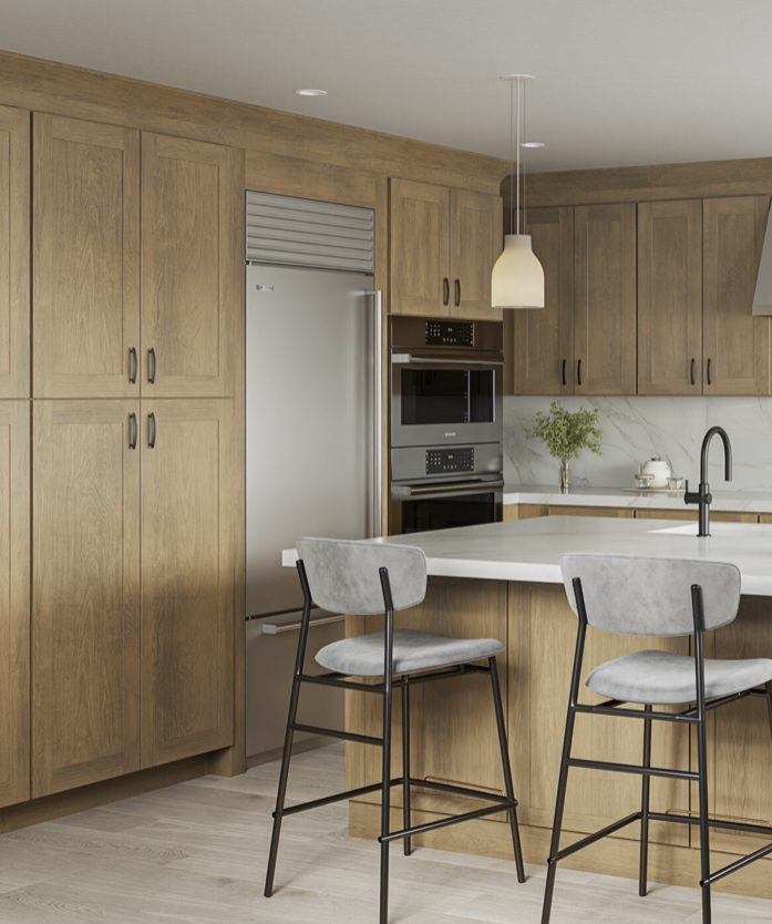 Kitchen with wooden cabinets, built-in stainless steel refrigerator, double oven, white kitchen island with two gray upholstered bar stools, pendant light, black faucet, and potted plant on the counter.