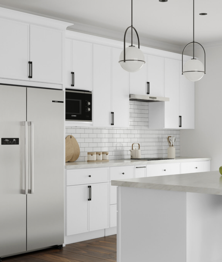 Modern white kitchen with black handles, stainless steel refrigerator, built-in microwave, white subway tile backsplash, pendant lights, and kitchen utensils.