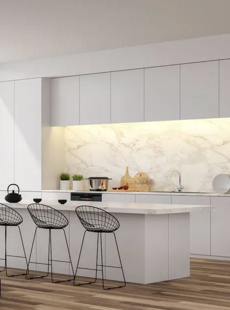 Modern kitchen with white cabinetry, marble backsplash, and a white island with black wire bar stools.