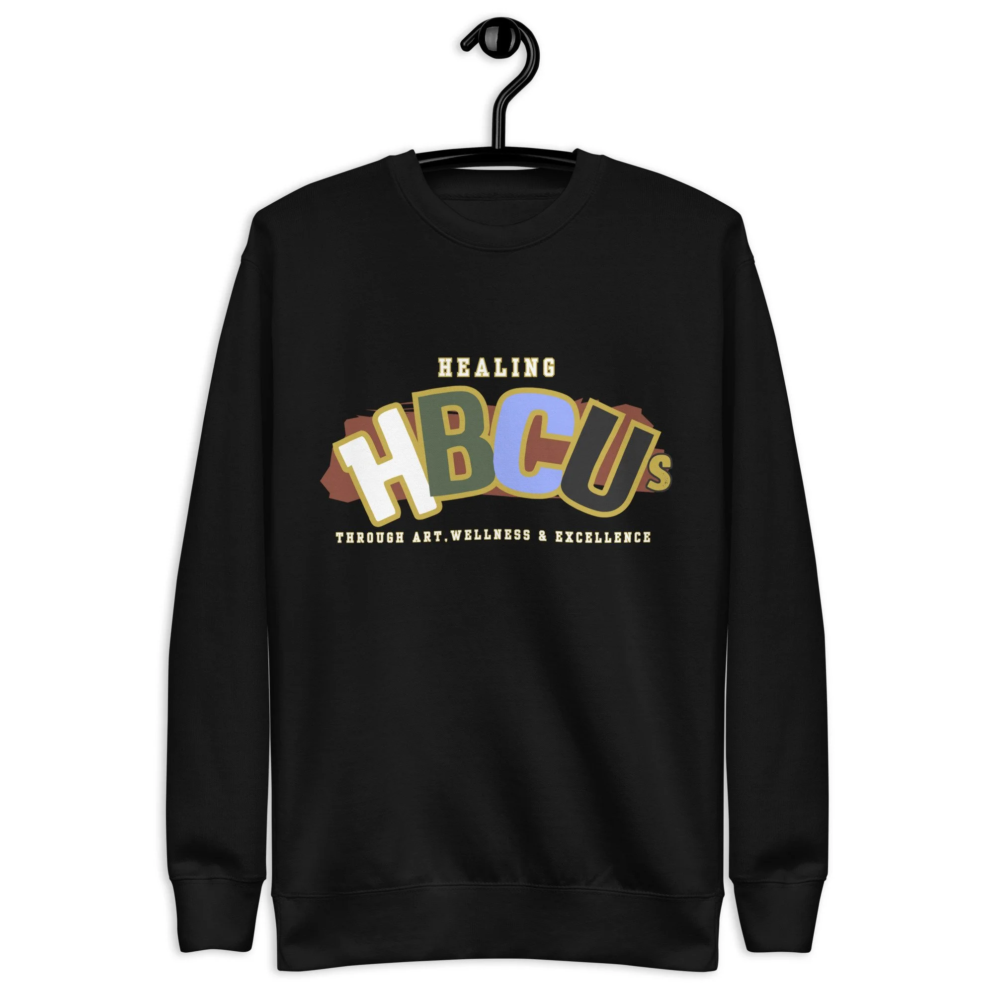 Black crewneck sweatshirt hanging on a hook with a colorful design and the word "HEALING" above the design.