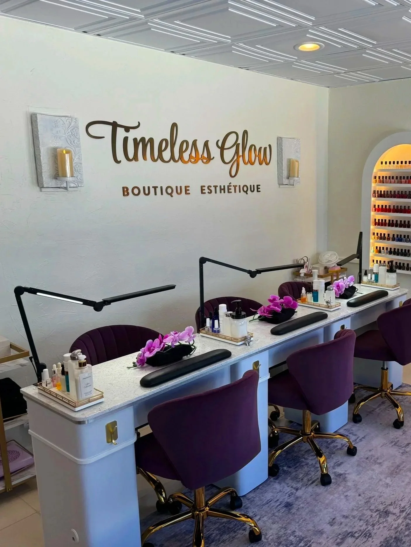Alt text: Interior photograph of Timeless Glow Studio, a nail salon and spa in Delray Beach, Florida, showing the staff work area where nail treatments are performed, including manicure stations, tools, and salon seating arranged for service.