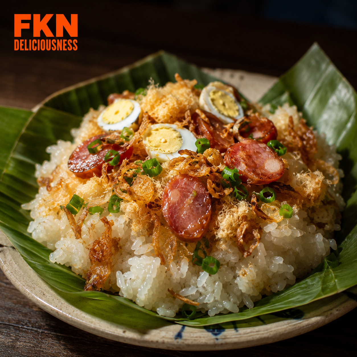 Xôi mặn, Vietnamese savory sticky rice topped with sliced Chinese sausage, pork floss, quail eggs, scallion oil, and crispy fried shallots.