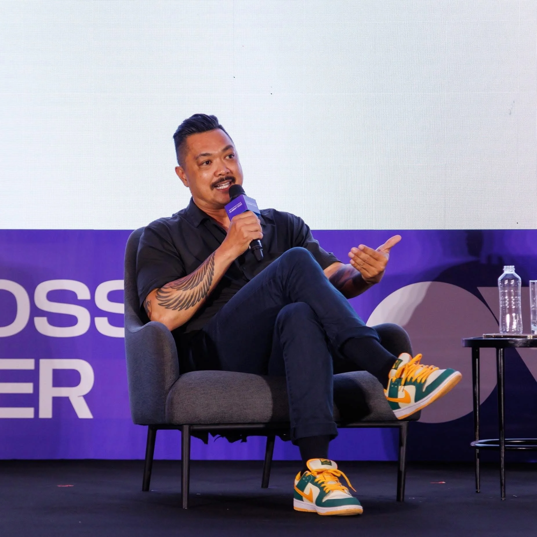 Calvin Bui speaking on stage about food, storytelling, and his experience living and cooking in Vietnam.
