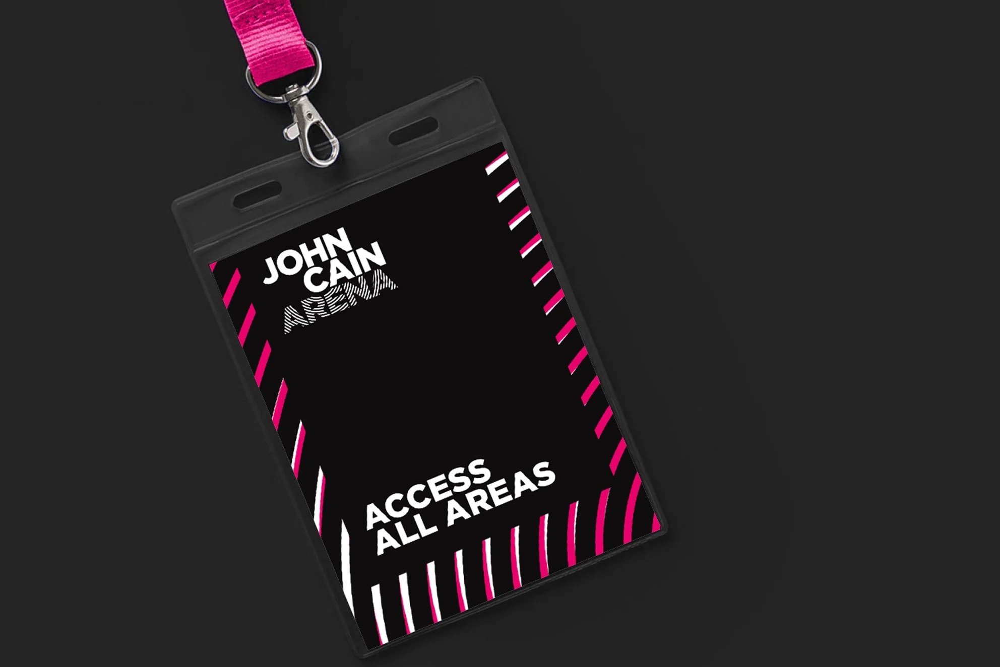 Badges indicating access to all areas, attached to a pink lanyard, with black background.