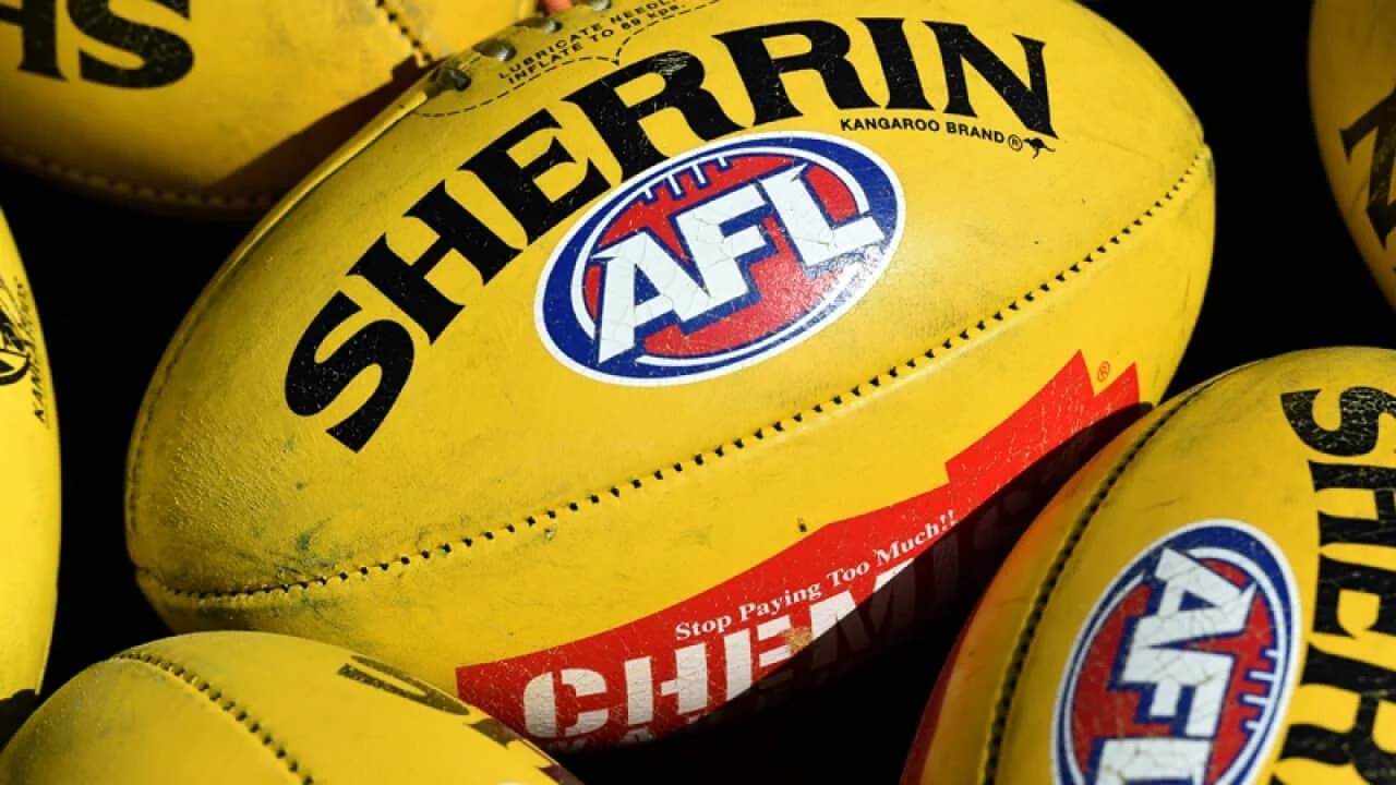 Yellow football with AFL and Super Bowl logos and red and white warning label.
