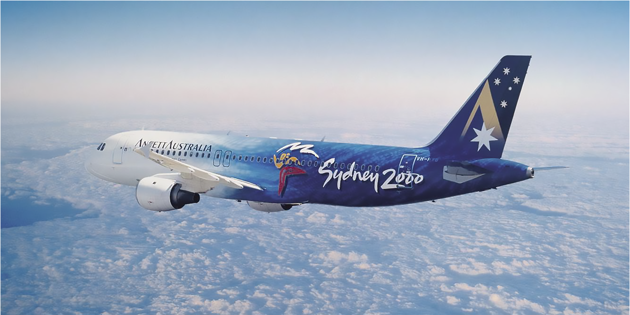 An airplane flying above the clouds with Sydney 2000 Olympics branding on its blue tail and fuselage.