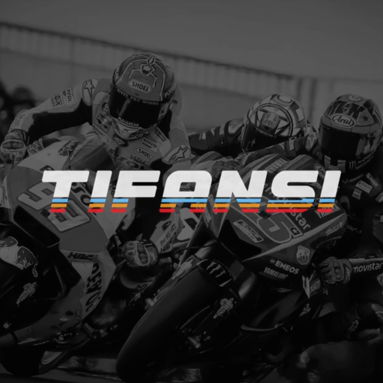 Black and white photo of professional motorcycle racers in a competitive race, with a colorful 'Tifansi' overlay.
