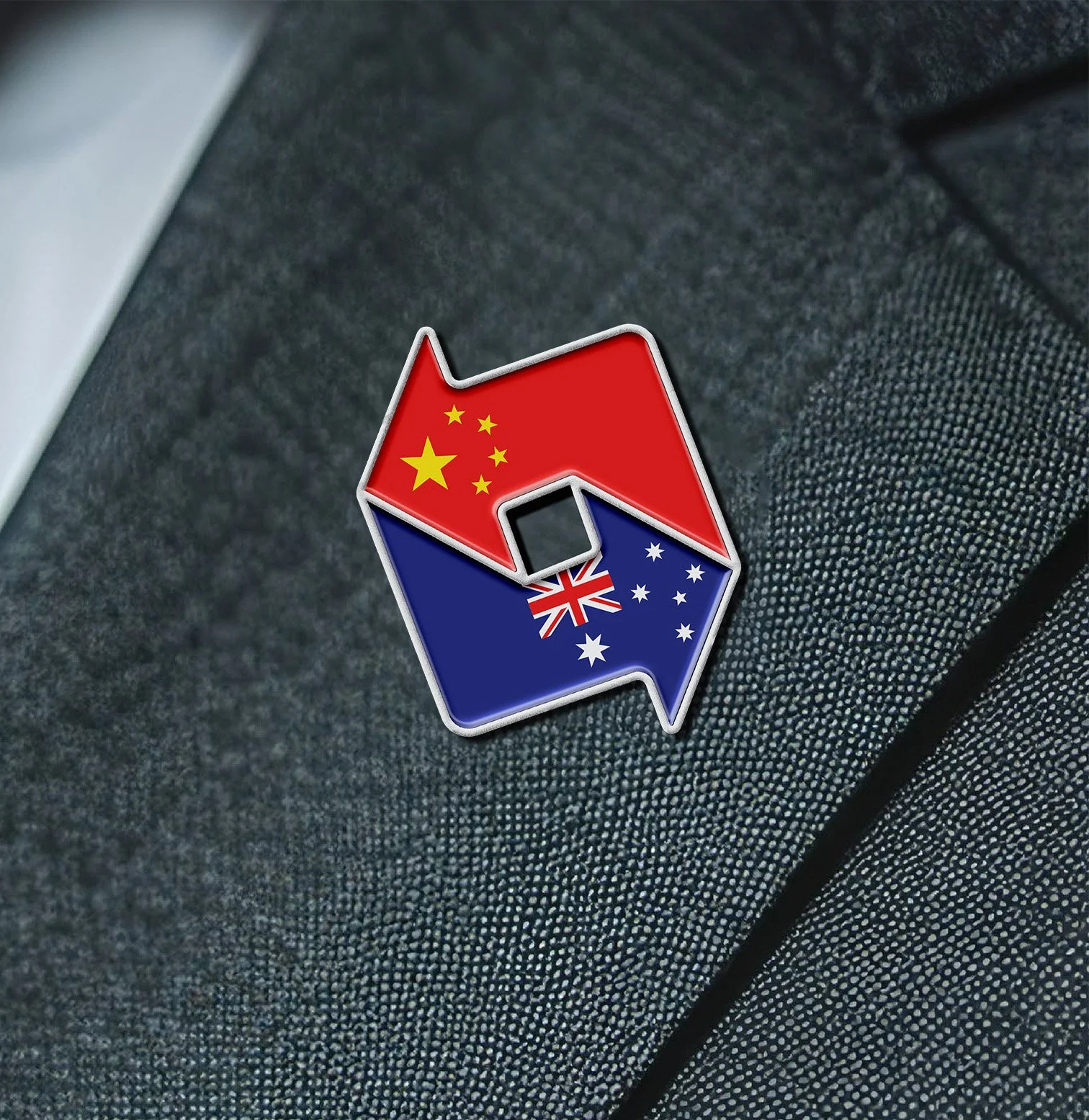 A pin with the stars and stripes of the Australian flag and the red with yellow stars of the Chinese flag, overlapping and arranged in a zigzag pattern.