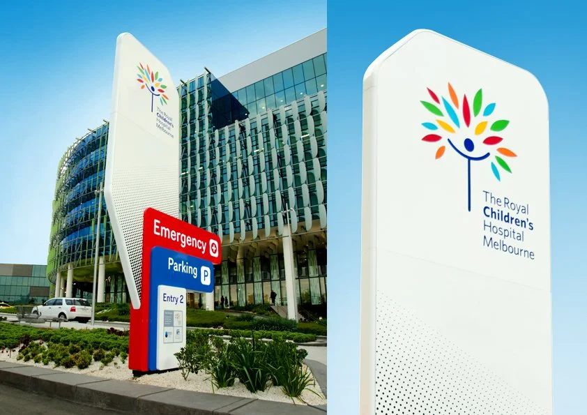 Exterior view of The Royal Children's Hospital Melbourne, featuring a modern building with glass windows and a large sign with the hospital's logo and name.
