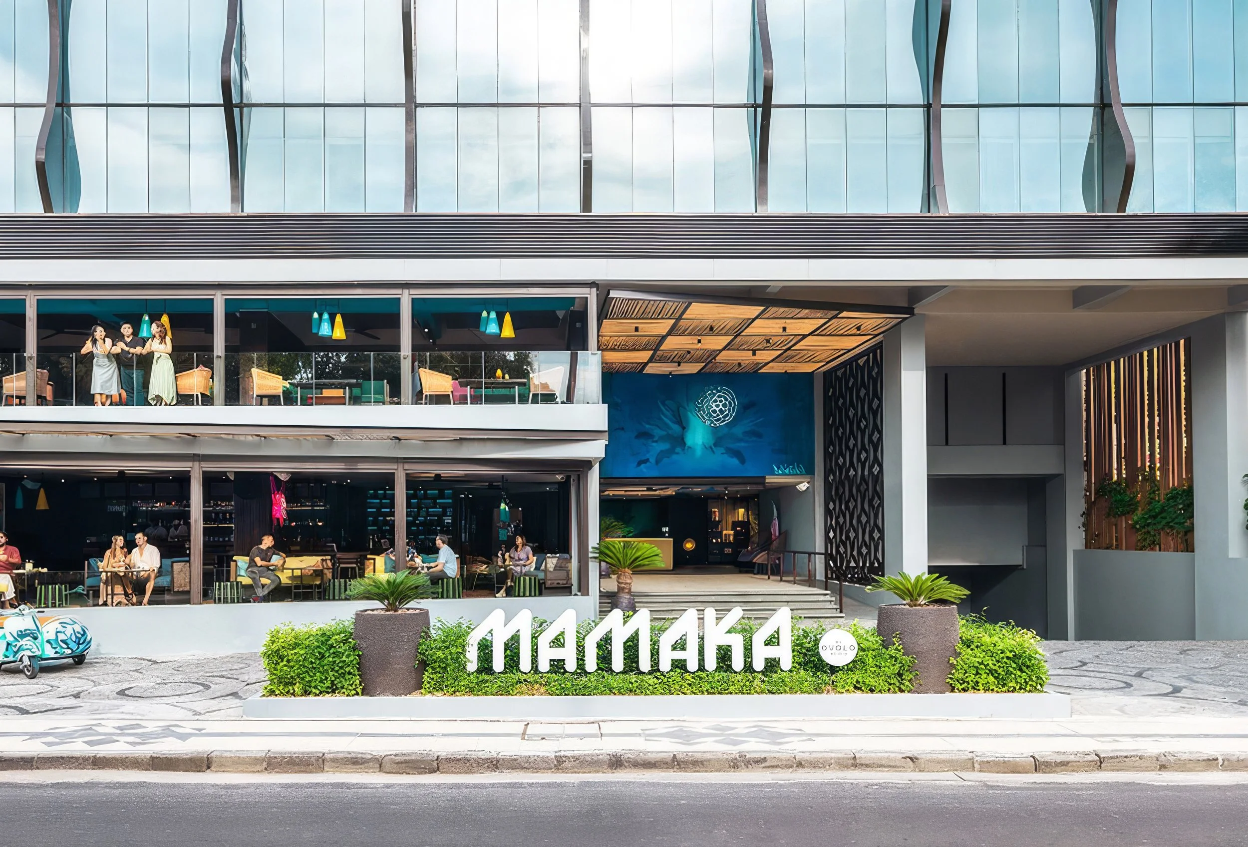 A modern multi-story building with glass windows, outdoor seating areas with 'Mamaka" brand at the front. The building features colorful pendant lights and a mural of a turtle on the blue wall. Potted plants are visible in the foreground.