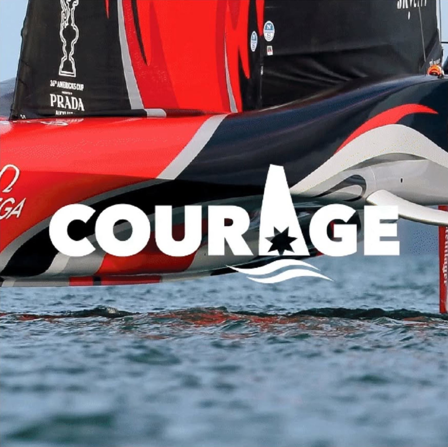 A sailboat with a red, black, and gray sail on calm water. The sail has a logo with a trophy and the text '38th Americas Cup'. The lower part of the sail also features the words 'COURAGE' in large white letters with a star in the 'A'.