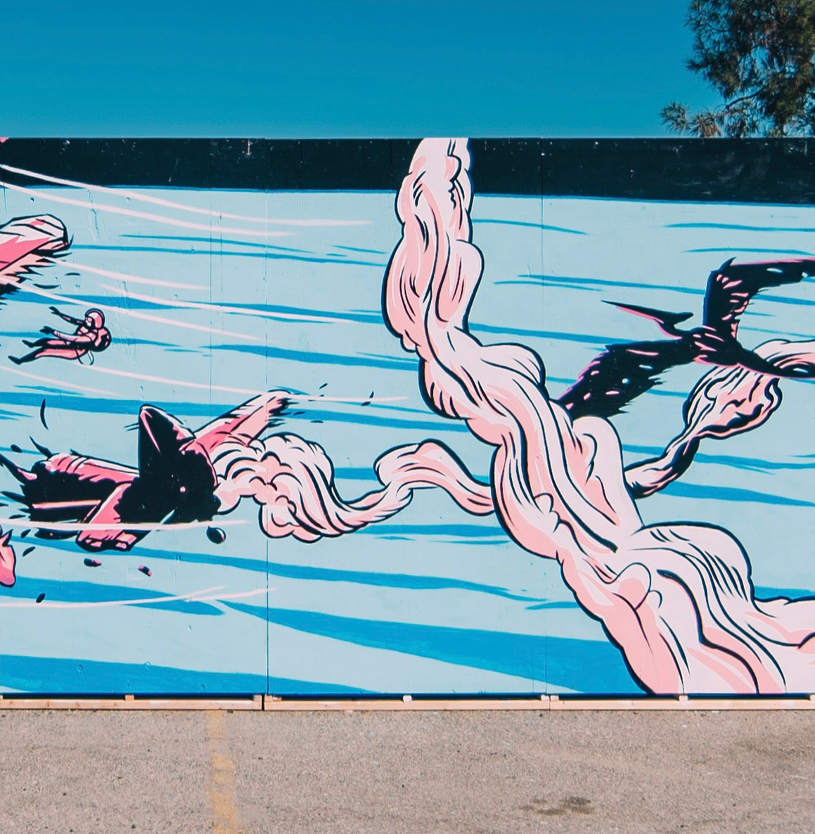 A colorful mural of a massive pink and black sea creature with large tentacles, surrounded by water with blue and white streaks, and a small swimmer nearby.