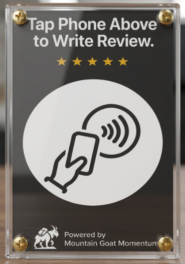 Sign instructing customers to tap phone above to write a review, with a contactless payment icon, and a logo of a mountain goat, indicating it is powered by Mountain Goat Momentum.