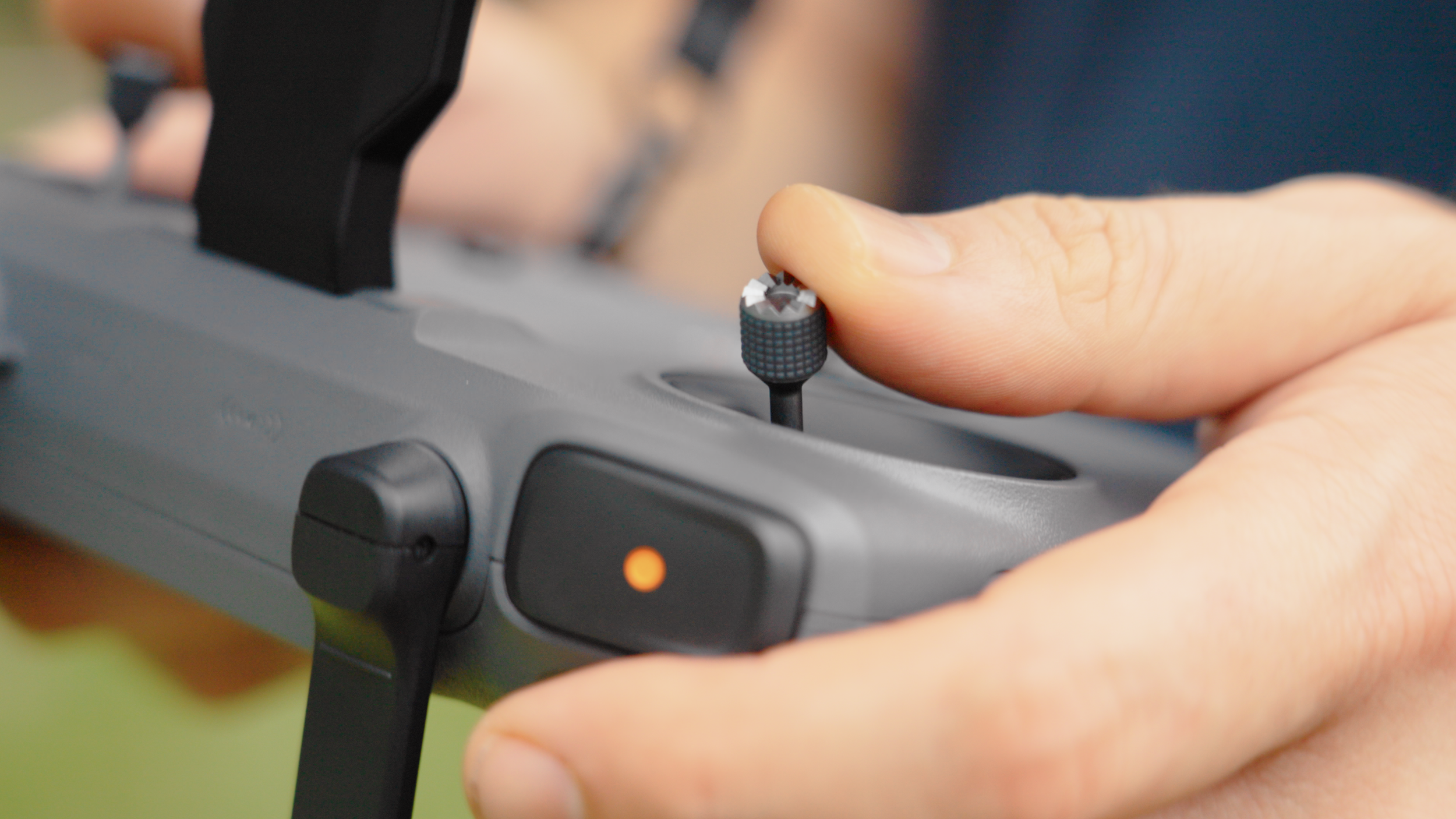 Close-up of someone's hand adjusting a knob on a professional DJ or audio equipment.
