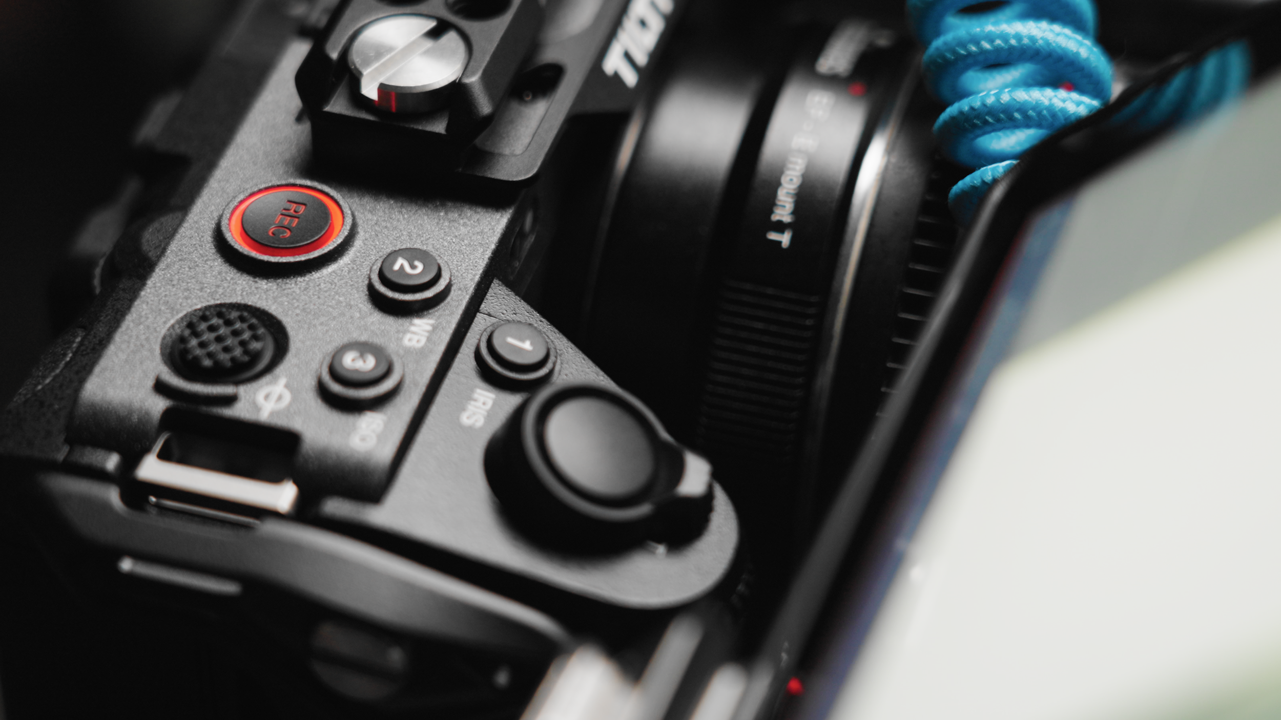 Close-up of a professional video camera showing various control buttons and dials.