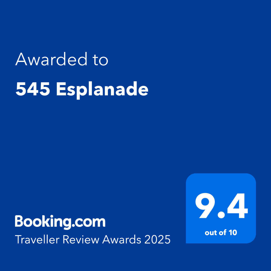 Booking.com award badge for 545 Esplanade with a 9.4 out of 10 rating in the Traveller Review Awards 2025.
