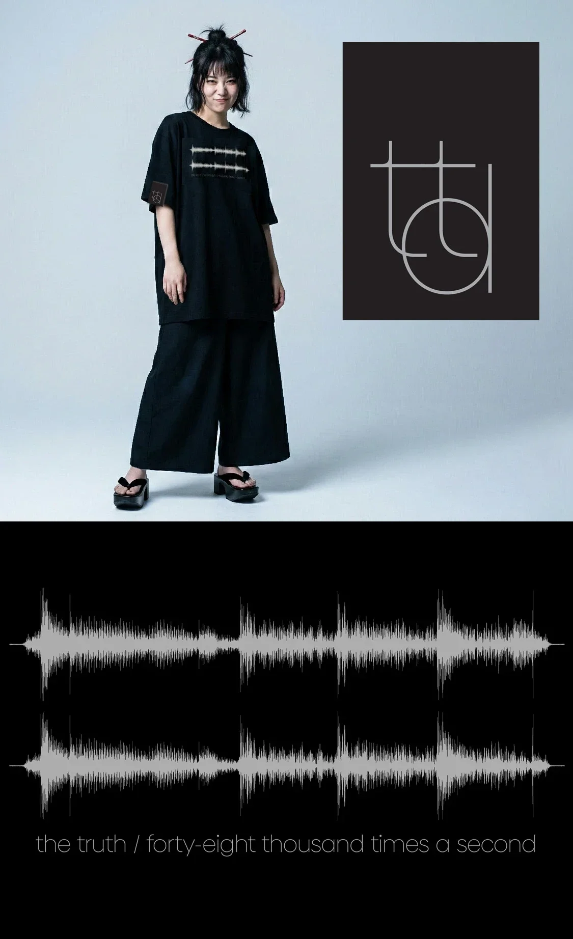A cool Japanese girl in a stylish black tee. The first merch from The Tapes, a future classic.