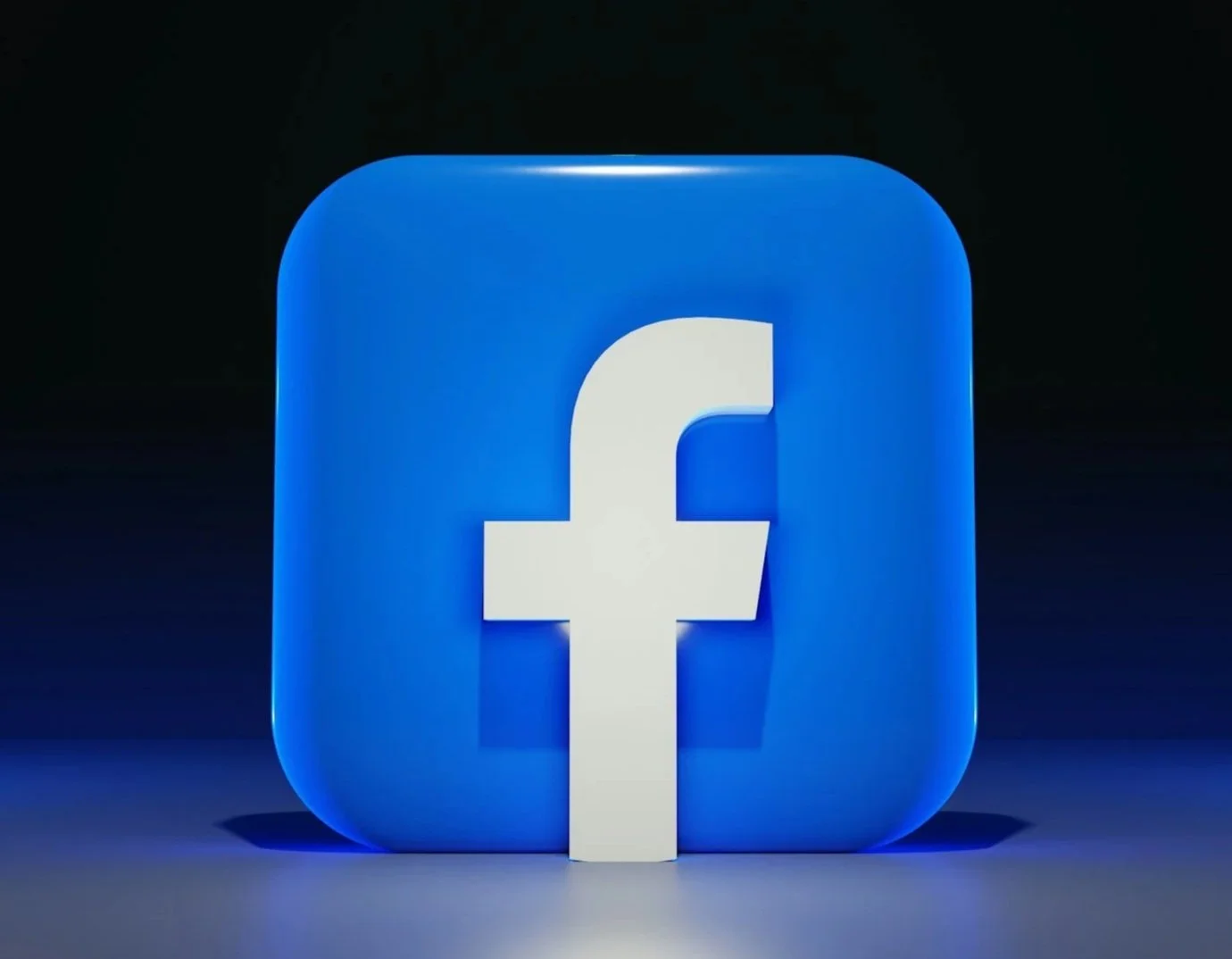 Facebook app icon as a large blue square with rounded edges and a white lowercase 'f' in the center, set against a dark background.