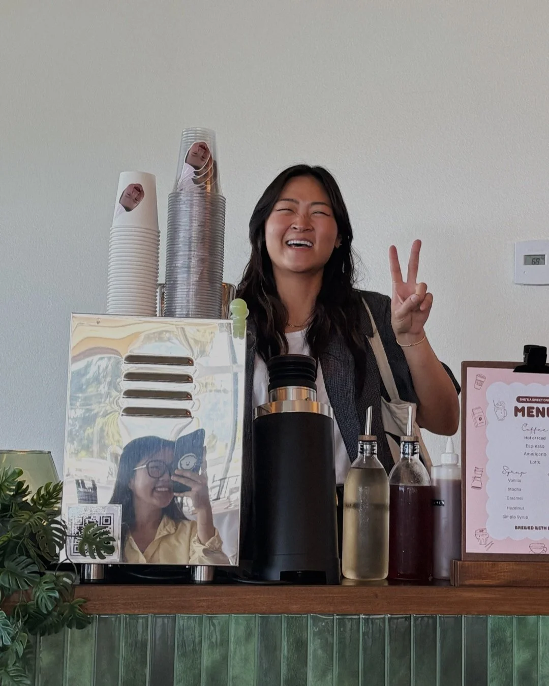 mingie smiling behind the bar