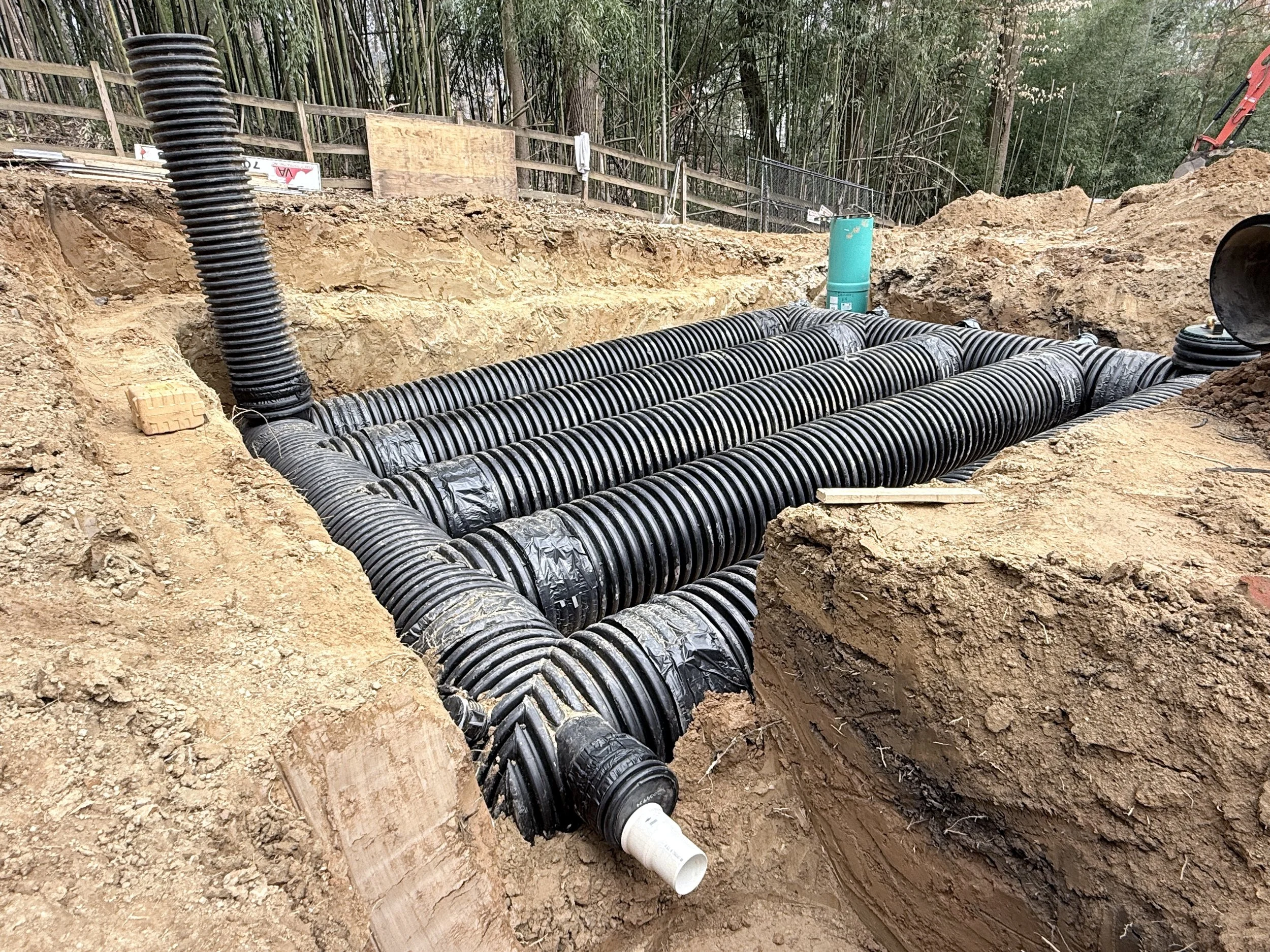Prefabricated HDPE stormwater detention manifold staged on a graded residential lot before underground installation in Northern Virginia.