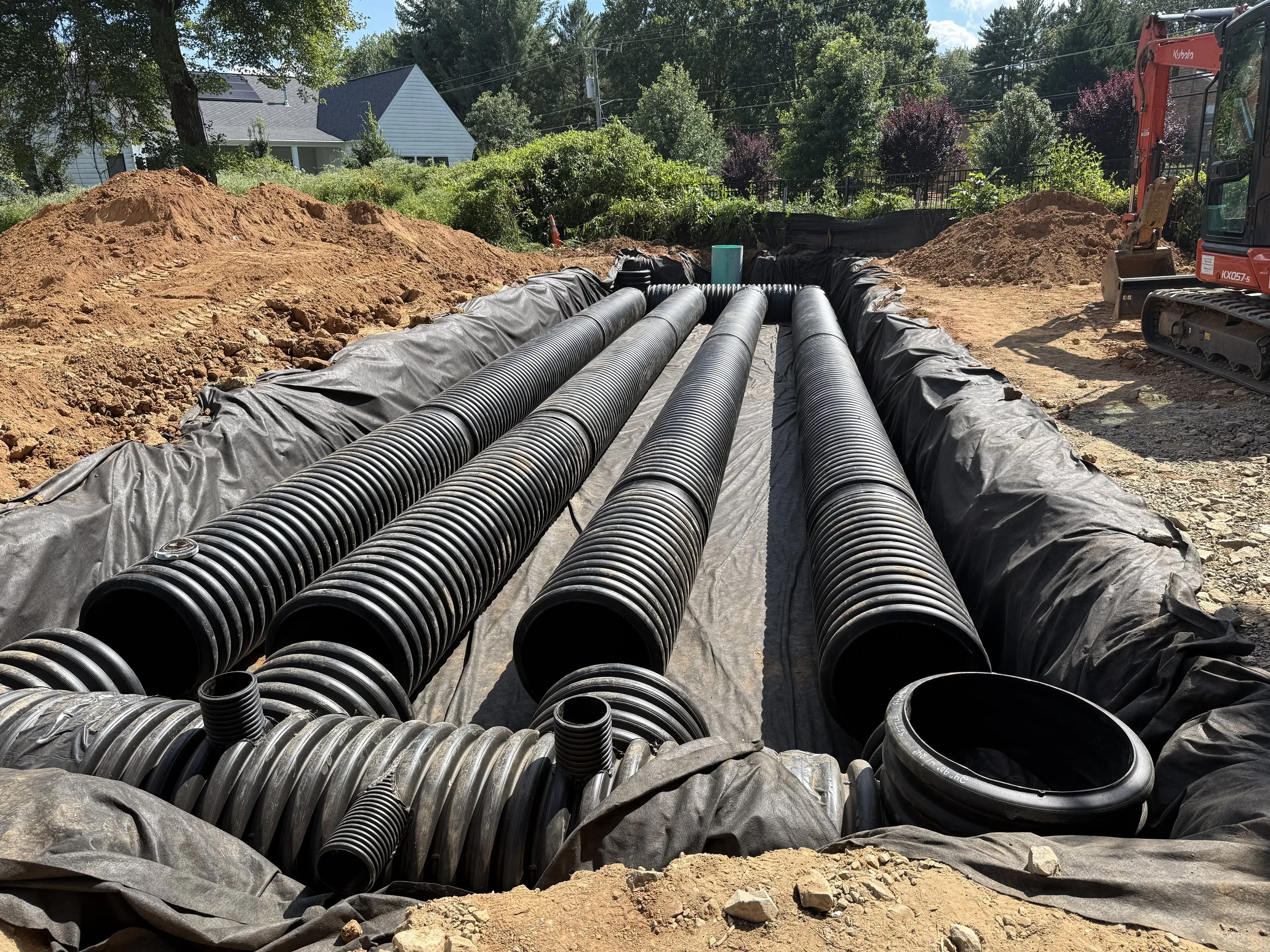 Prefabricated HDPE stormwater detention manifold staged on a graded residential lot before underground installation in Northern Virginia.