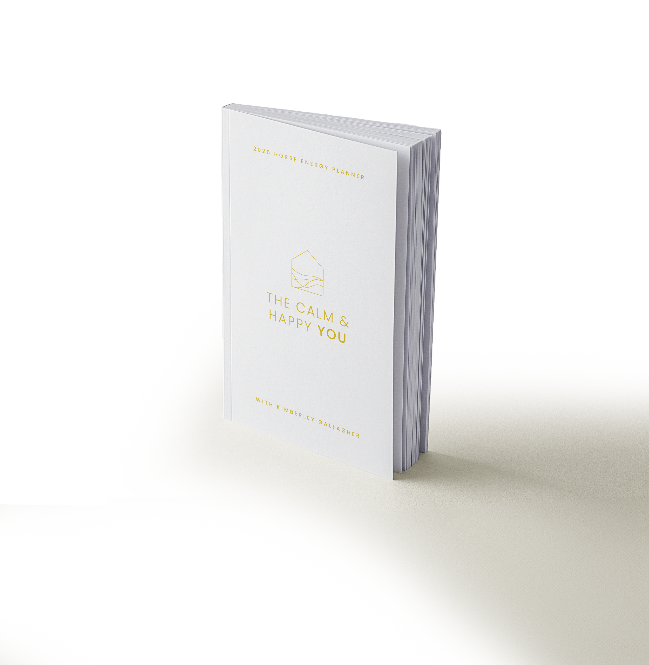 A white hardcover planner titled '2026 Horse Energy Planner' with gold lettering and a minimalist design, standing upright on a light surface.