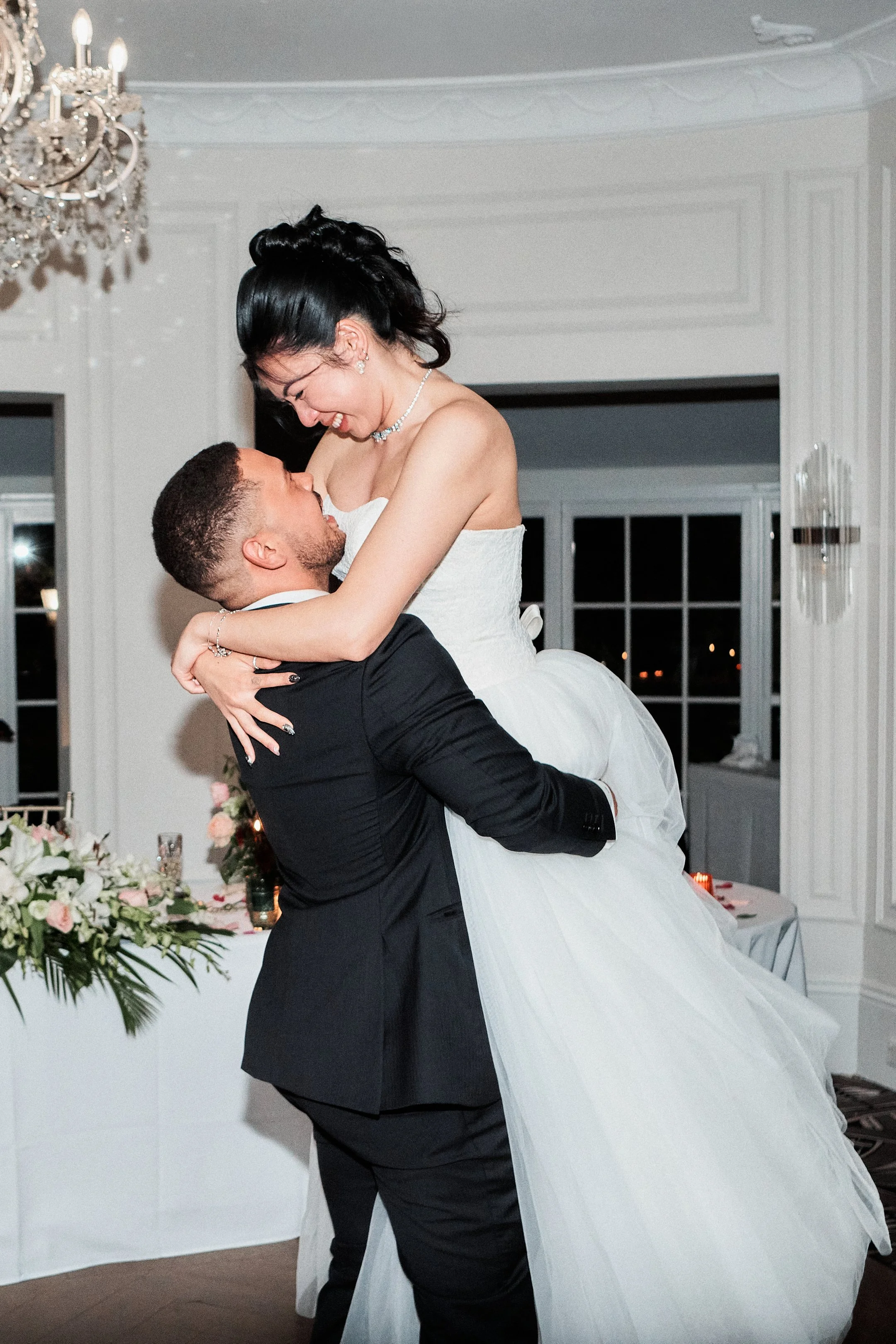 Wedding couple raised embrace at luxury reception in Sydney.jpg