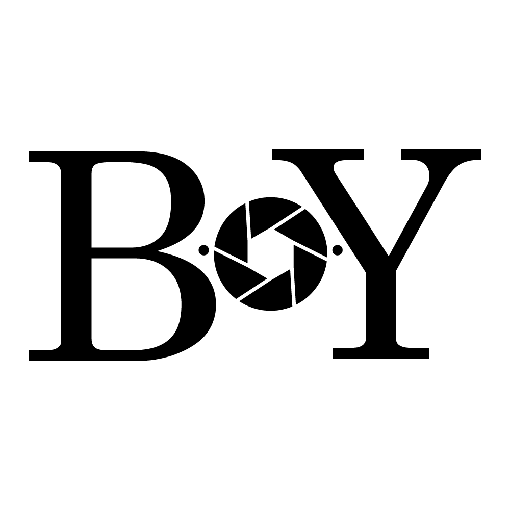 Graphic design with the word 'BOY' in large black letters, with the 'O' represented by a black camera shutter icon.