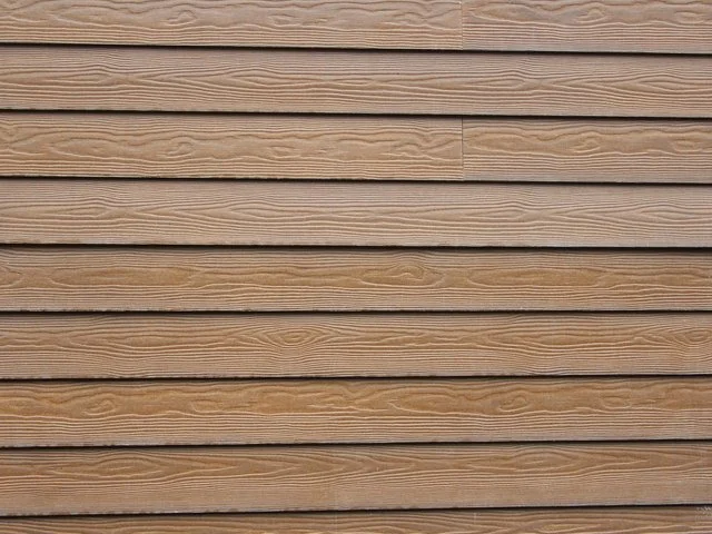 Close-up of horizontal wooden siding with natural wood grain.