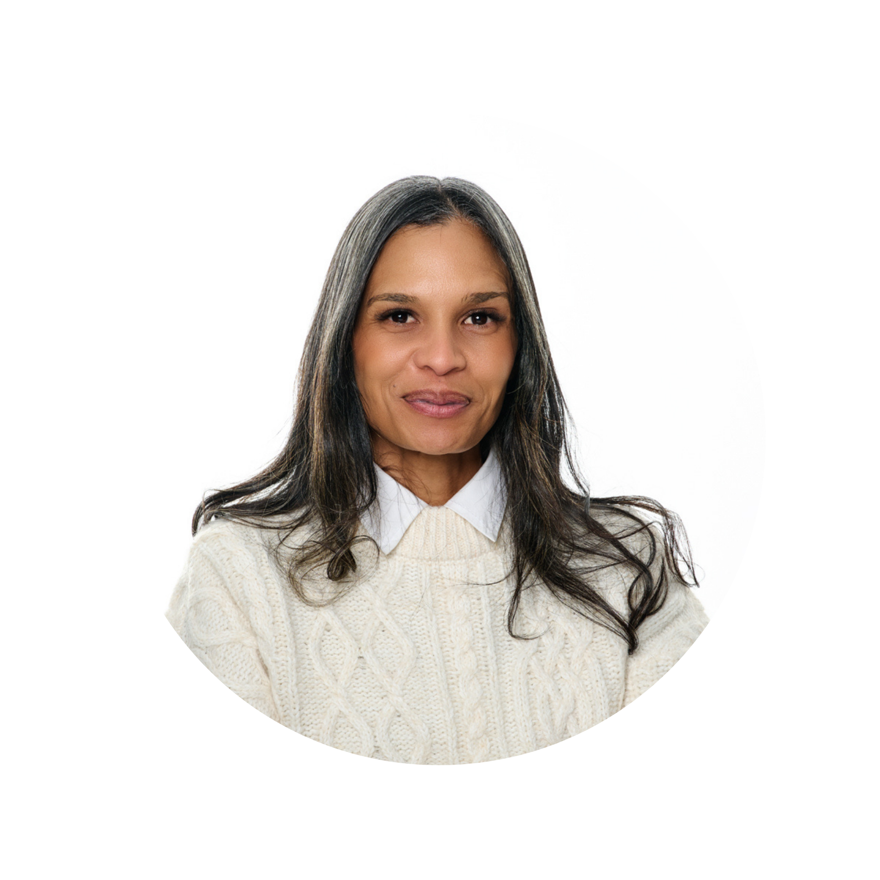 Portrait of a woman with long dark hair and gray streaks, wearing a cream-colored knit sweater and white shirt, smiling softly against a white background.