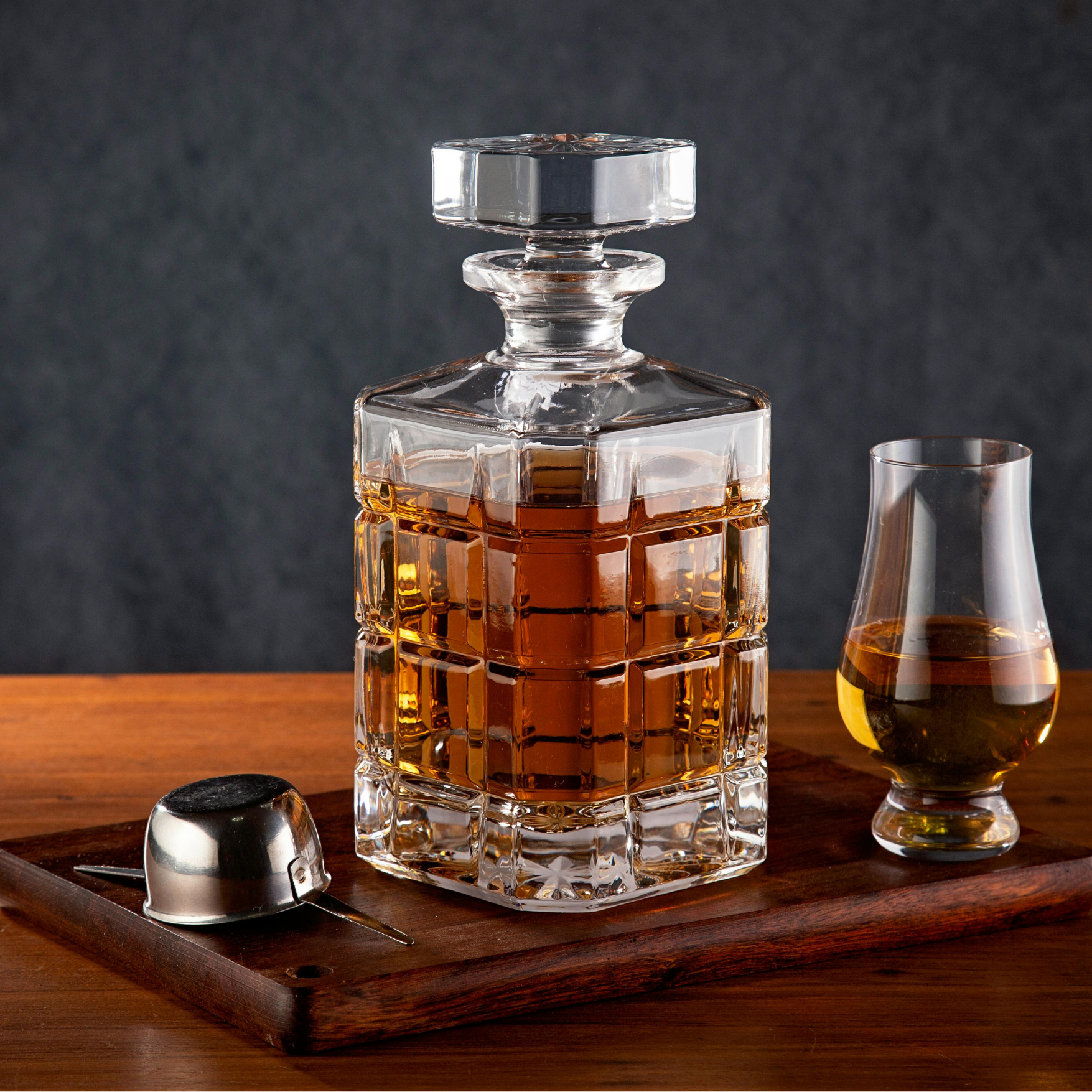 Crystal decanter and glass of amber whisky, Moya's premium liquor drop service, Cape Town.