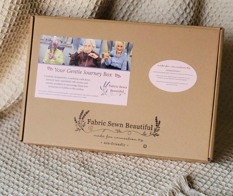 A brown cardboard activity box with Fabric Sewn Beautiful promotional stickers on the front