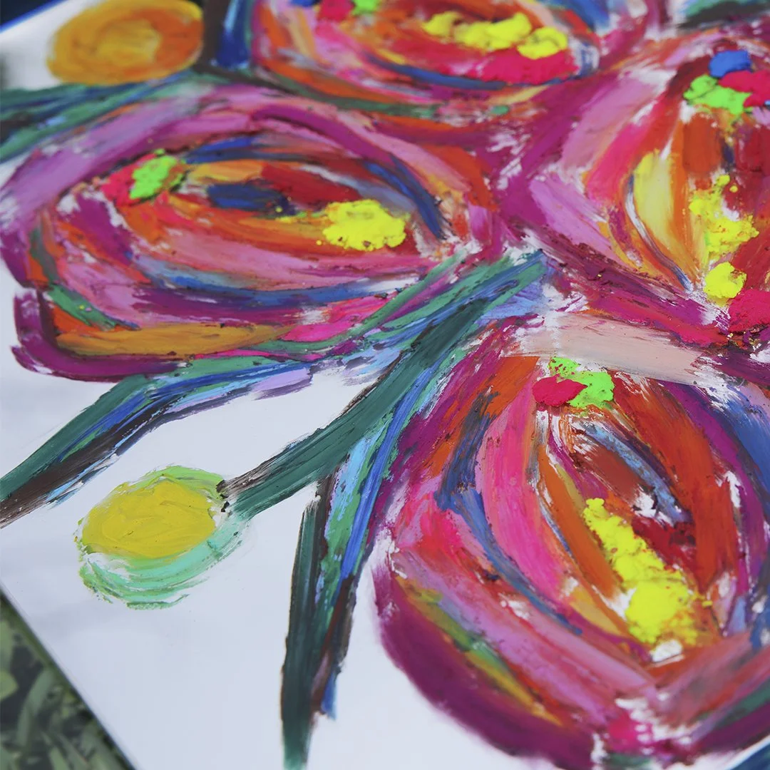 Close-up of a floral painting on a mirror grass, highlighting the vivid colors and intricate textures of the media.