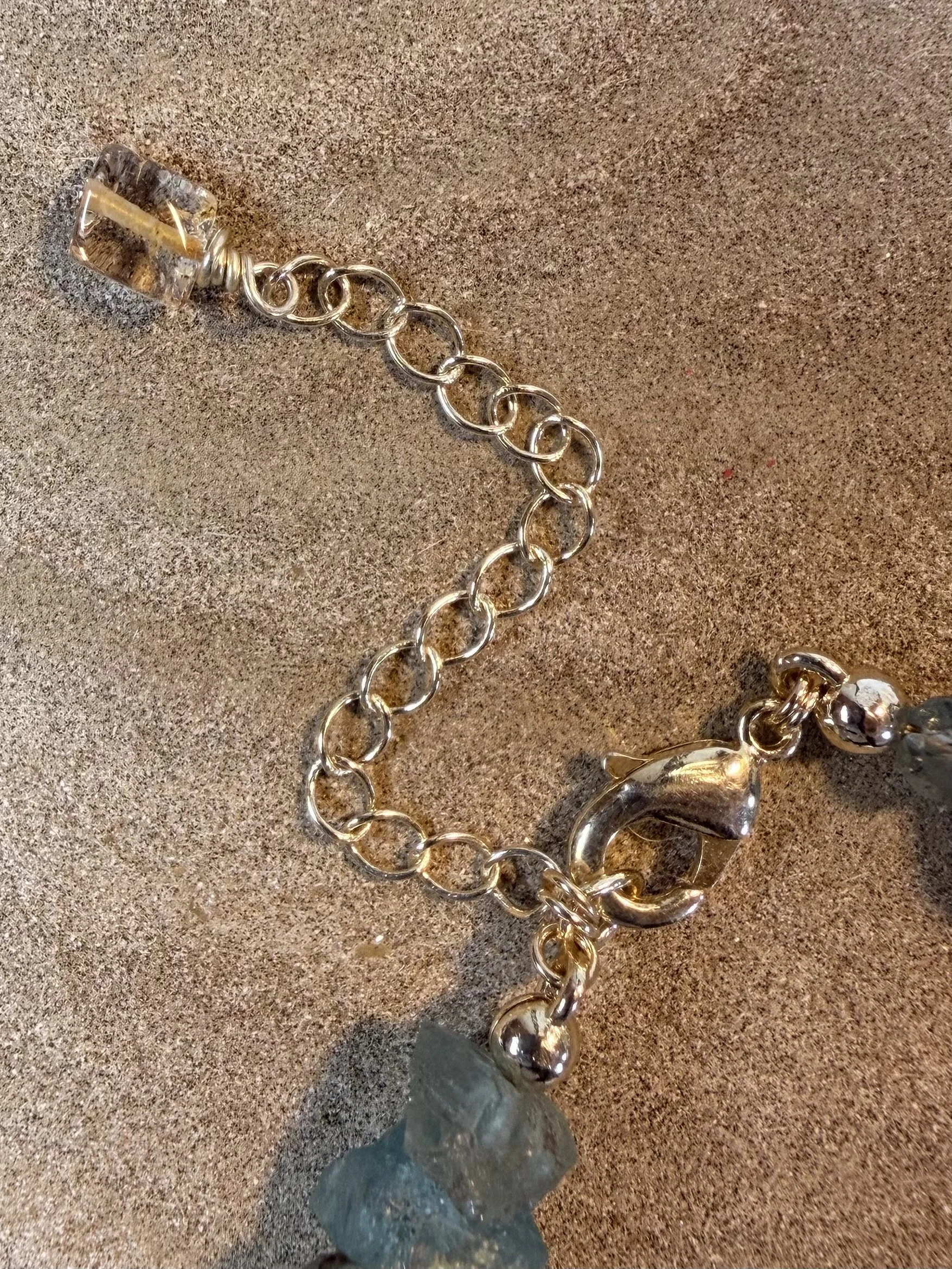 Close-up of the adjustable chain and lobster clasp of the gemstone bracelet.
