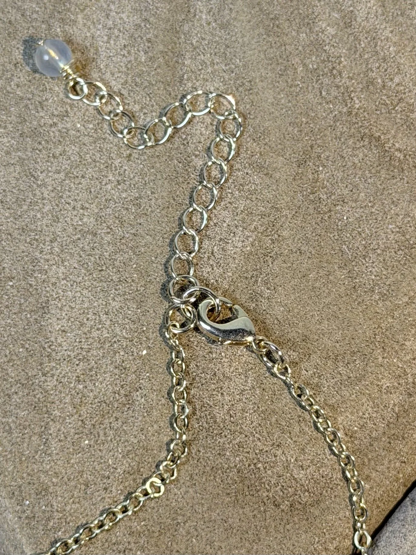 Close-up of the clasp and adjustable extender chain of the handmade gemstone necklace.