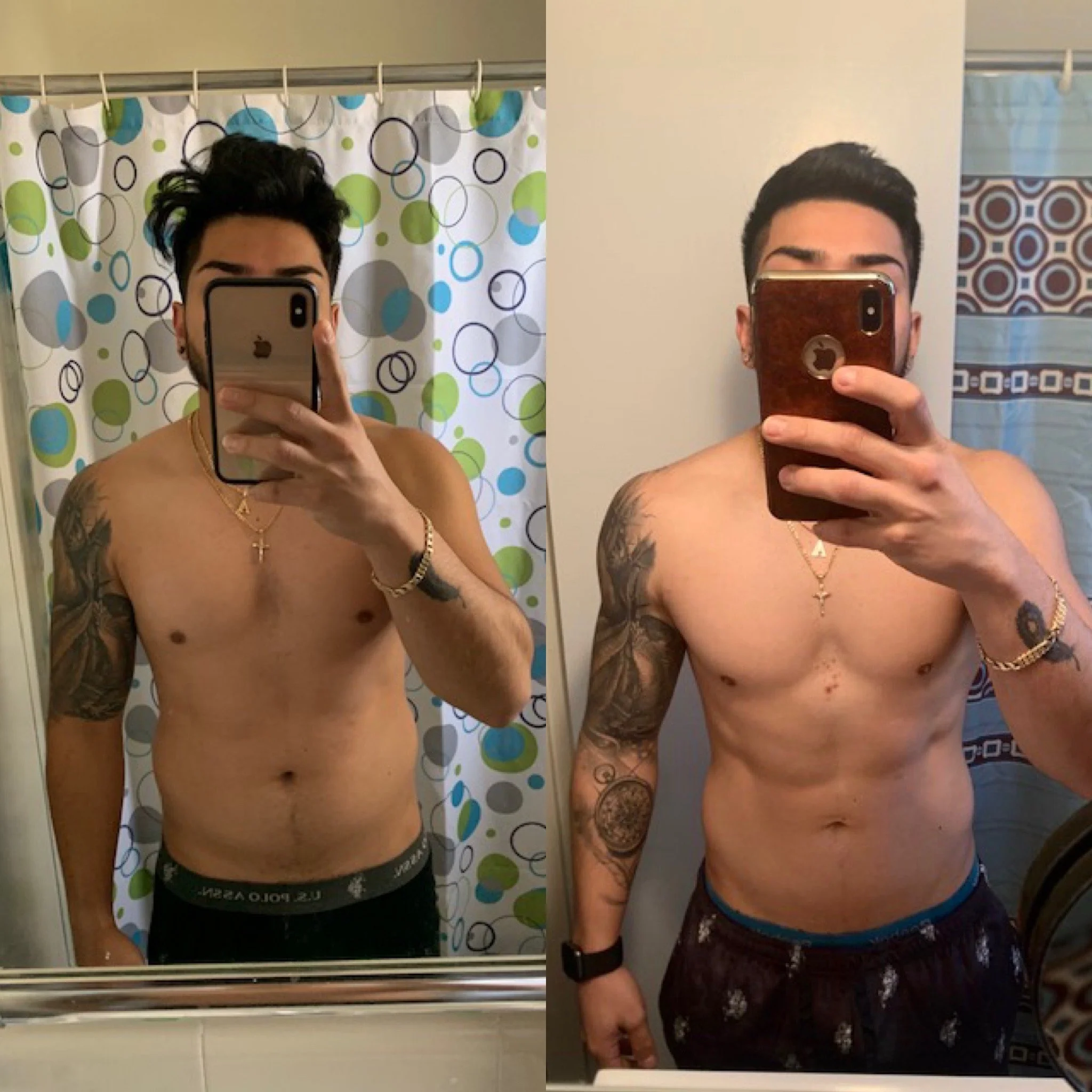 Two shirtless young men with tattoos taking mirror selfies in a bathroom. The man on the left wears black shorts, and the man on the right wears dark shorts with lace. Both have dark hair styled up. The background shows a bathroom with a colorful shower curtain on the left and a plain wall with a patterned shower curtain on the right.
