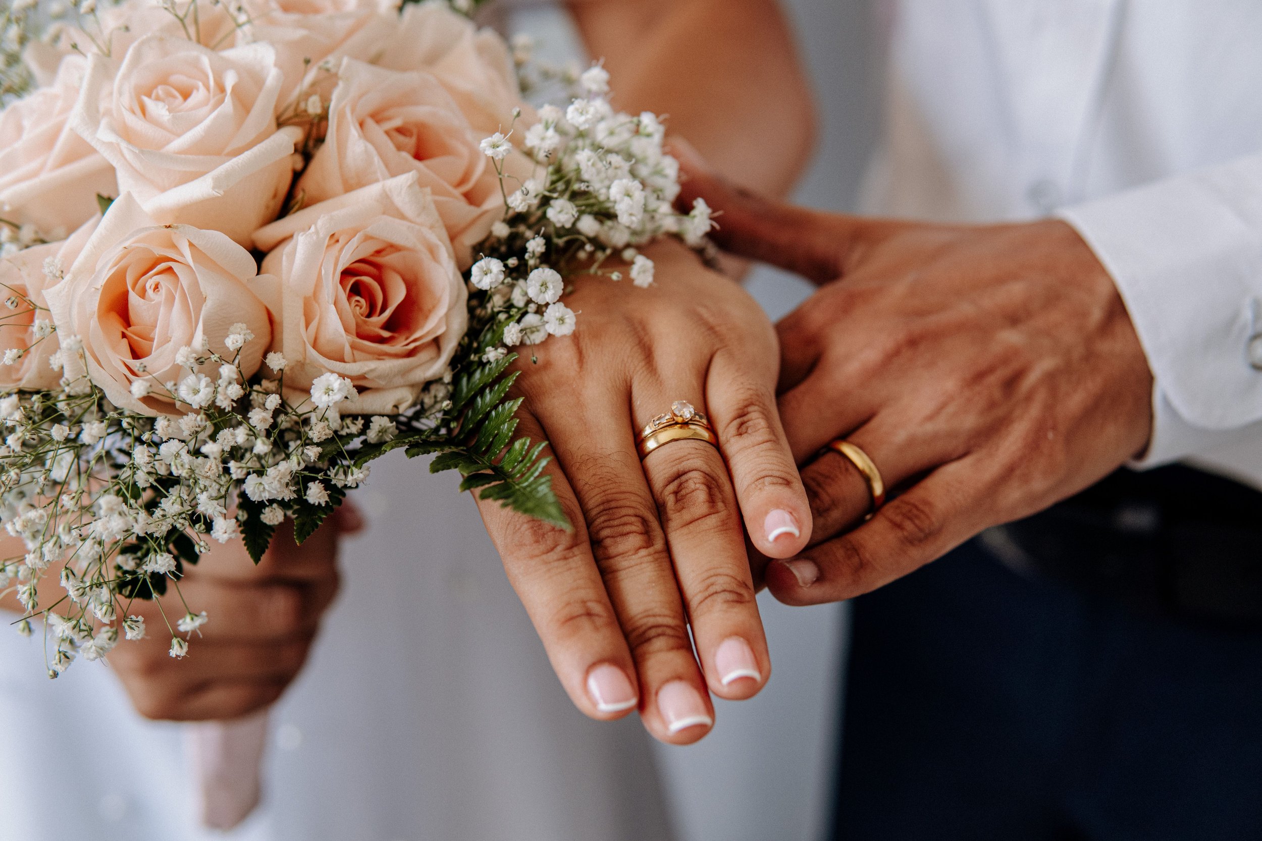 Bride and grooms hands showing the bride's wedding ring