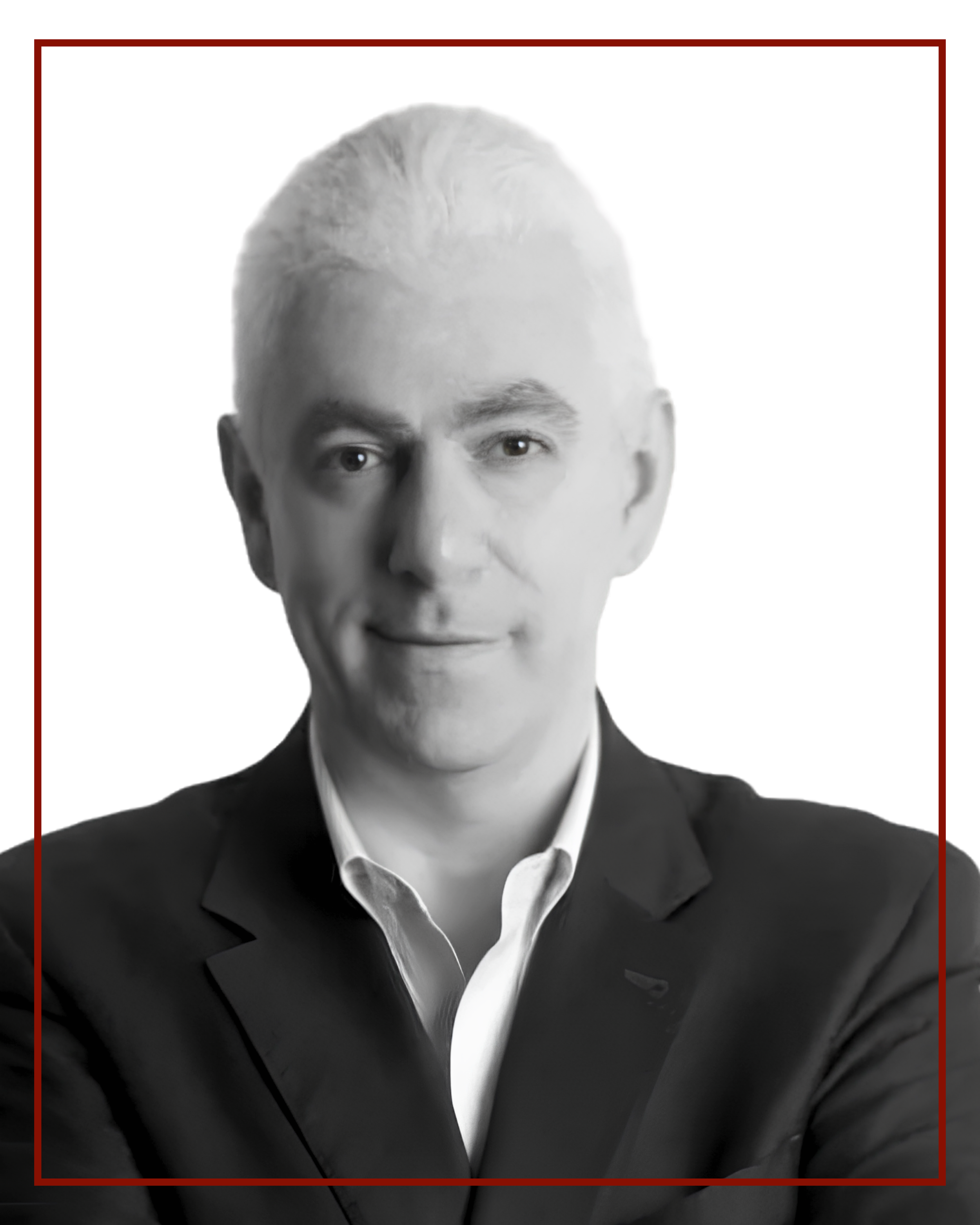 Black and white portrait of a man in a suit with a white shirt, seen from the chest up.