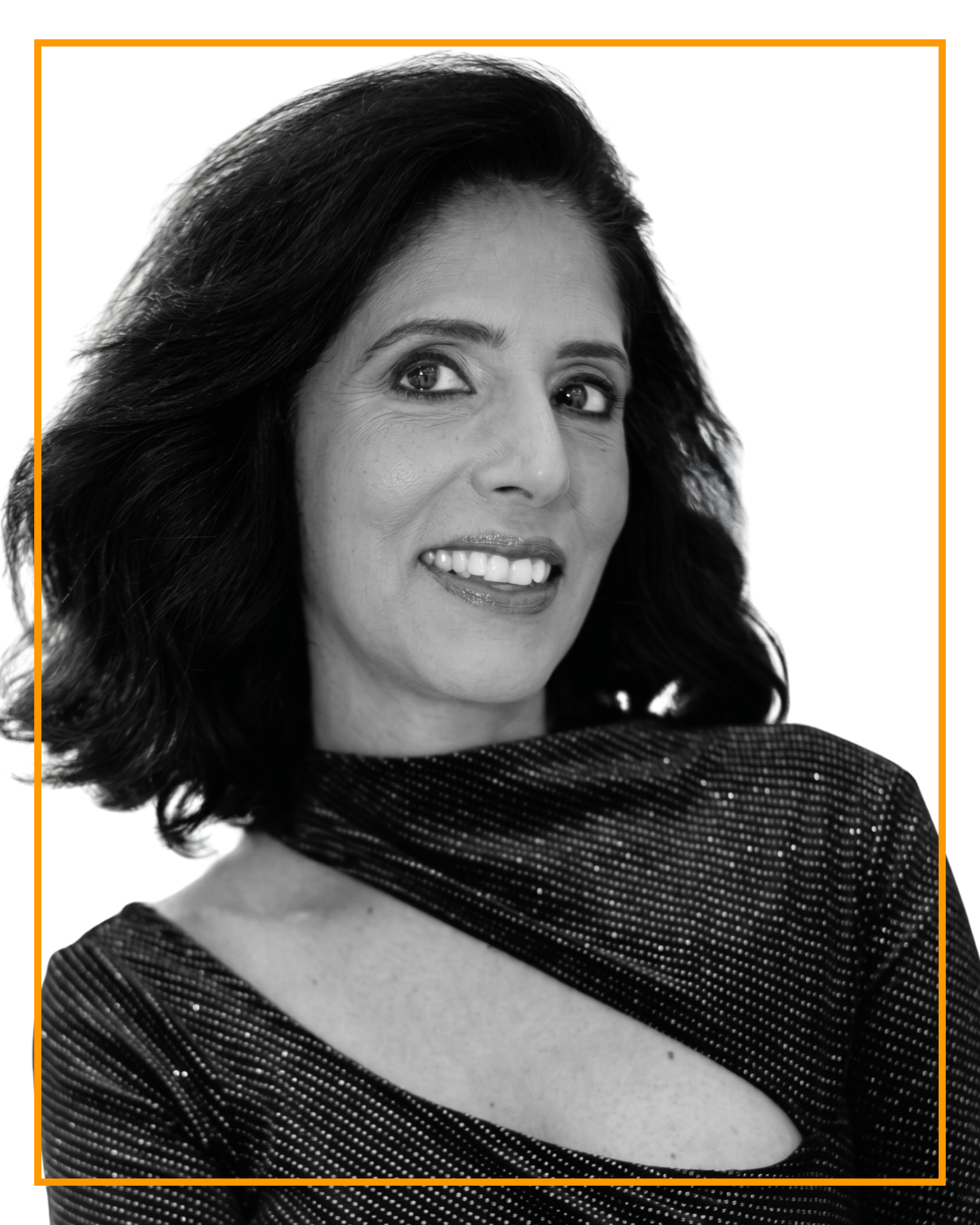 Close-up of woman smiling, with dark hair, wearing a polka-dot top, framed by an orange border.