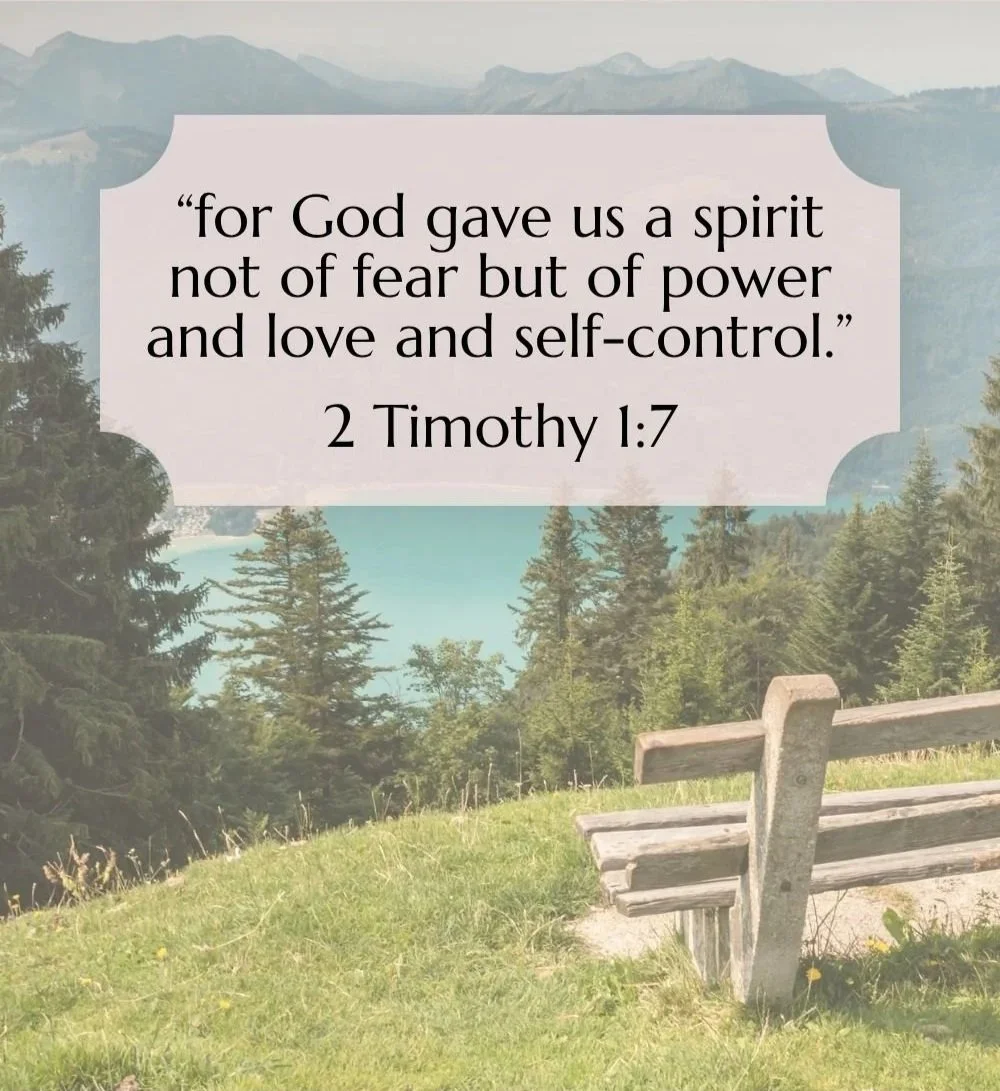 A scenic outdoor landscape with green grass, trees, and mountains in the background. Overlaid is a quote from 2 Timothy 1:7 that reads: 'for God gave us a spirit not of fear but of power and love and self-control.'