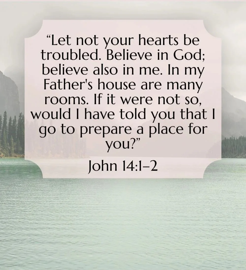 A scenic view of a lake with mountains and trees in the background, overlaid with a quote from John 14:1-2 about faith and preparing a place for believers.