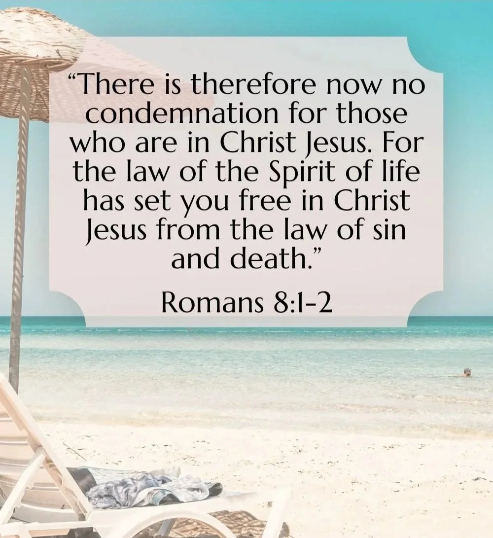 Beach scene with a lounge chair, umbrella, and ocean, overlaid with a Bible verse from Romans 8:1-2 about freedom from condemnation through Christ Jesus.