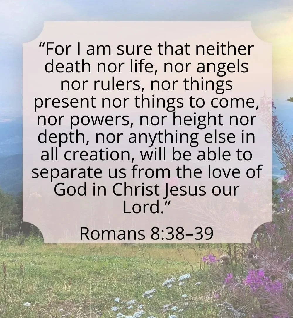 A quote from Romans 8:38-39 over a background of a scenic landscape with grass, trees, and mountains, and a partly cloudy sky.