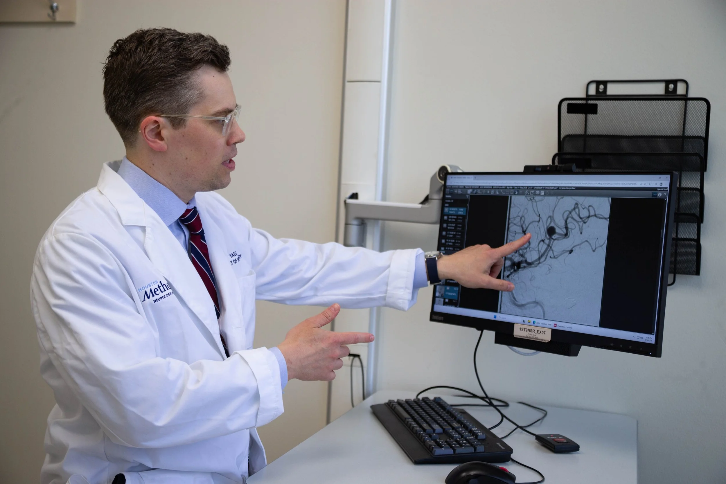 Dr. Kurt Yaeger reviewing a patient's brain imaging on a monitor