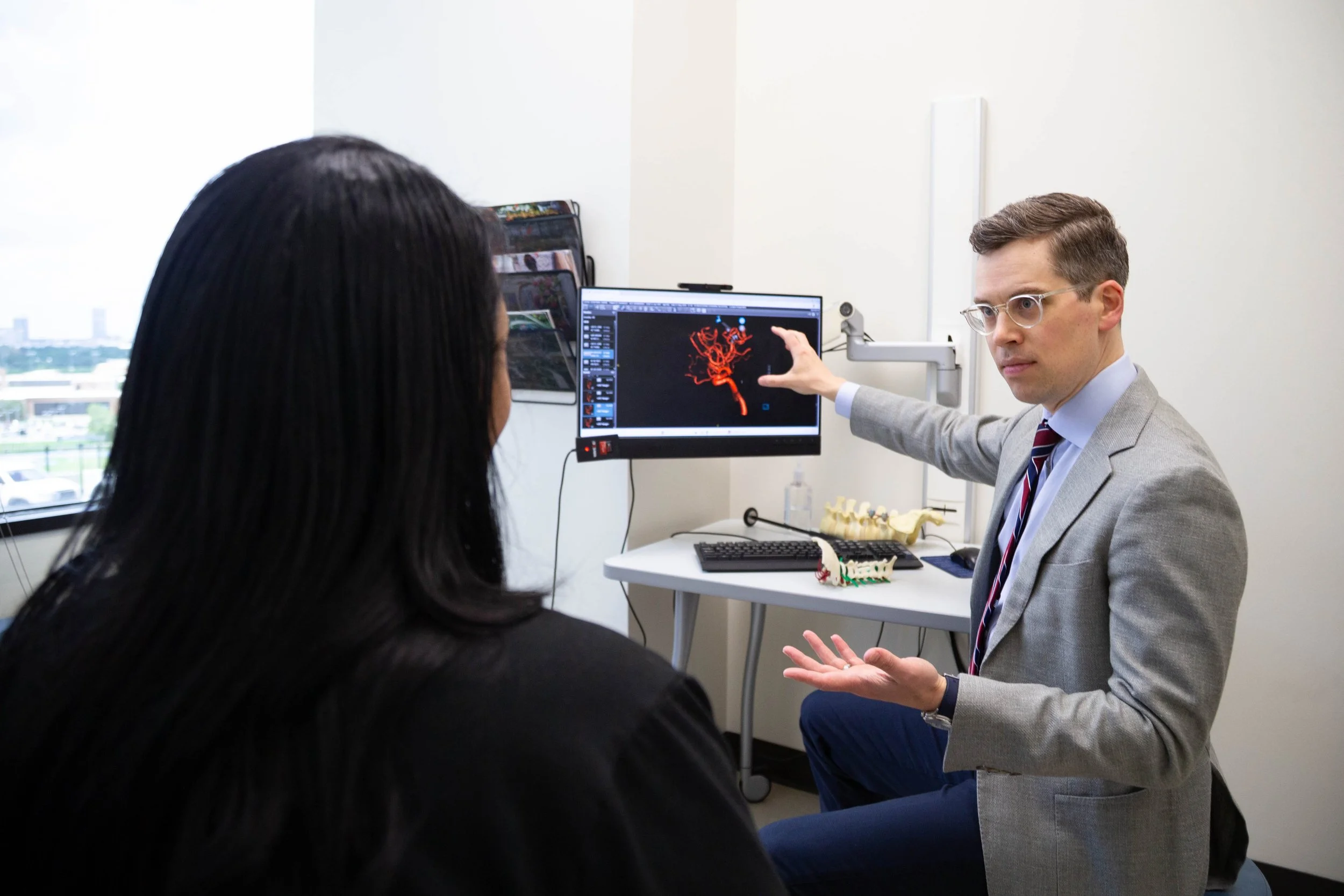 Dr. Kurt Yaeger explaining a brain scan to a patient