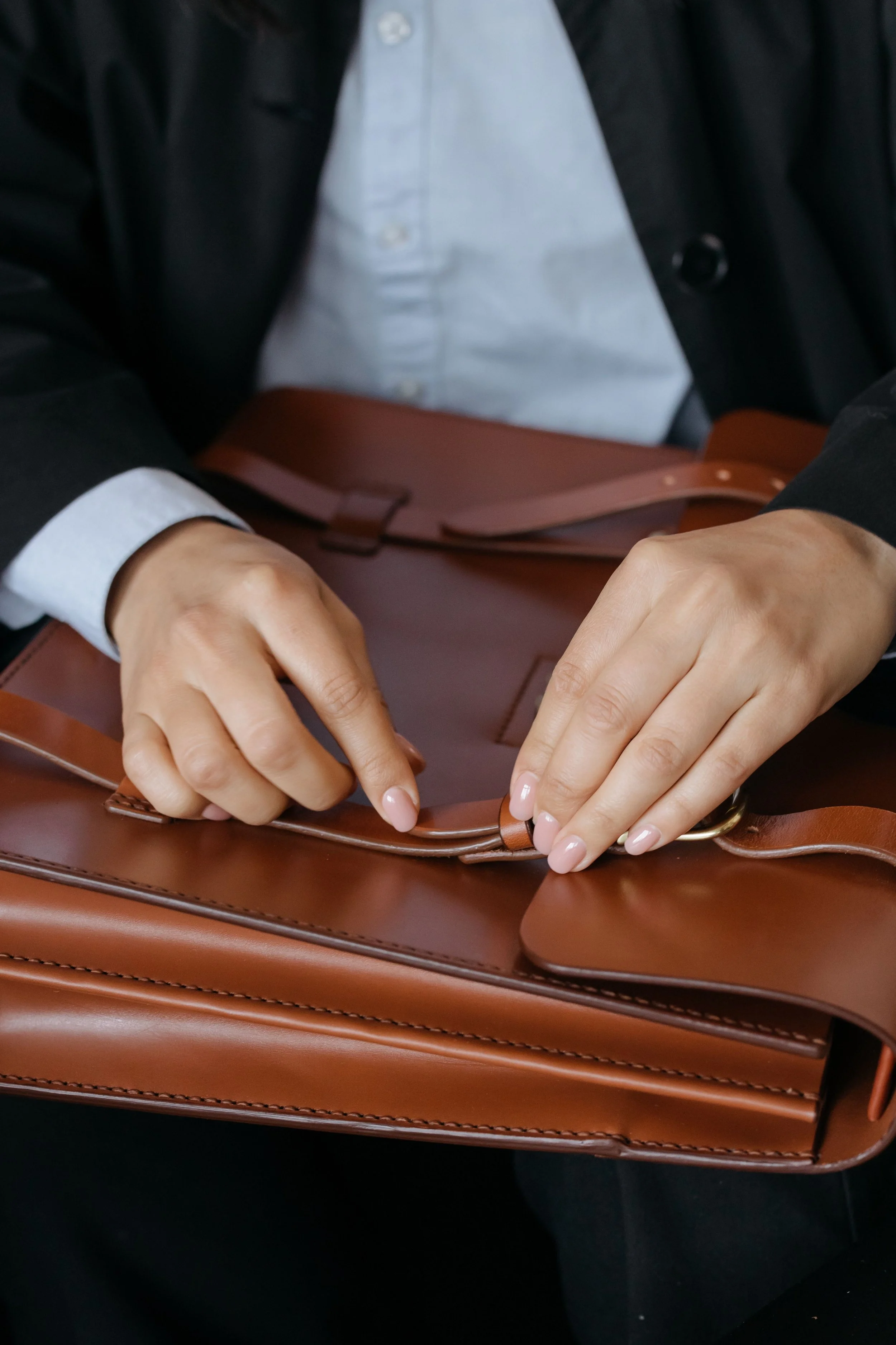 A woman holding a high quality leather traveling bag