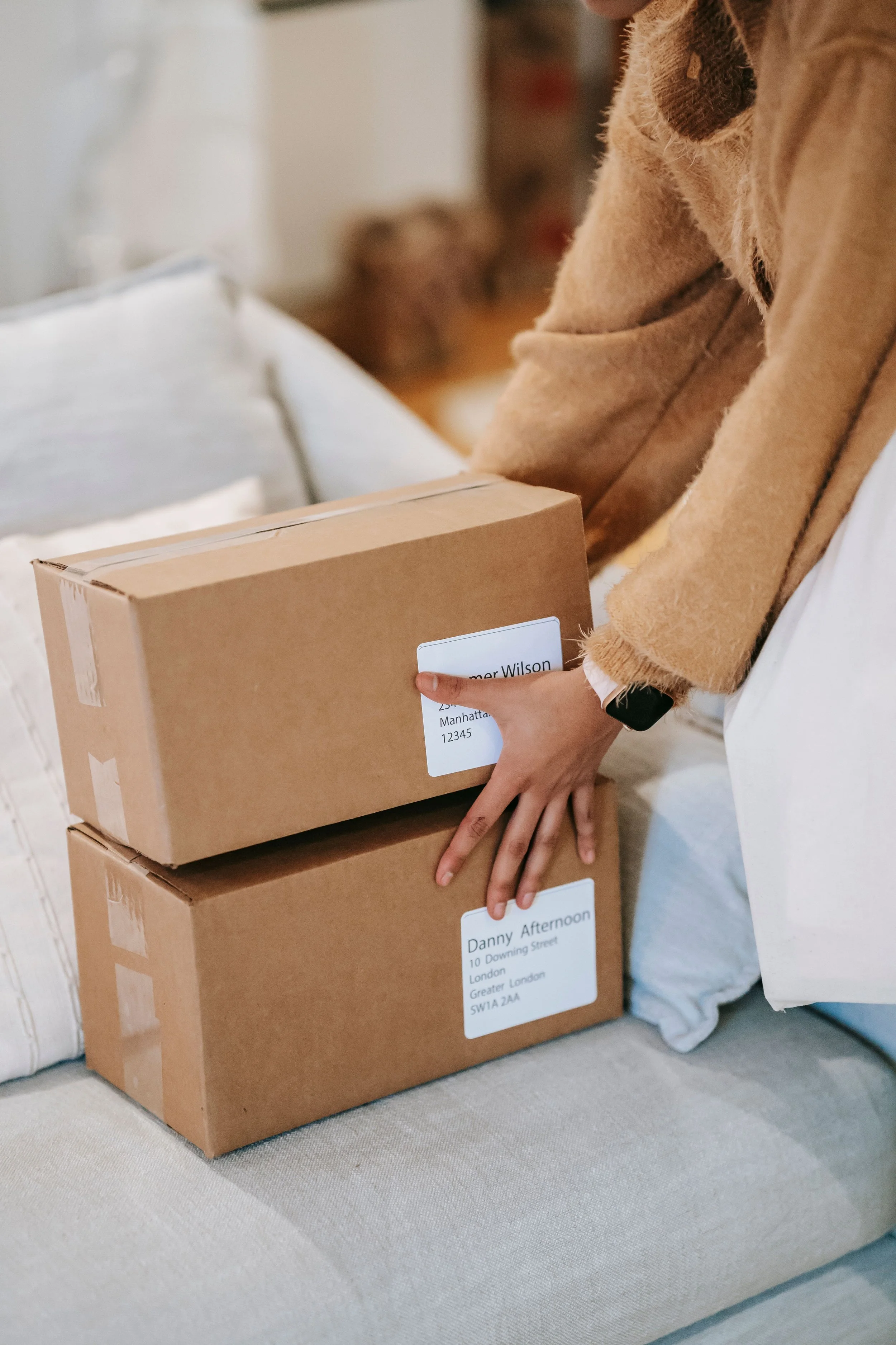 A woman handing delivery boxes in perfect conditions