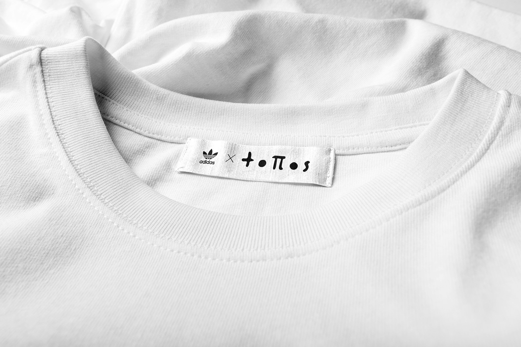 Adidas x topos collab tag