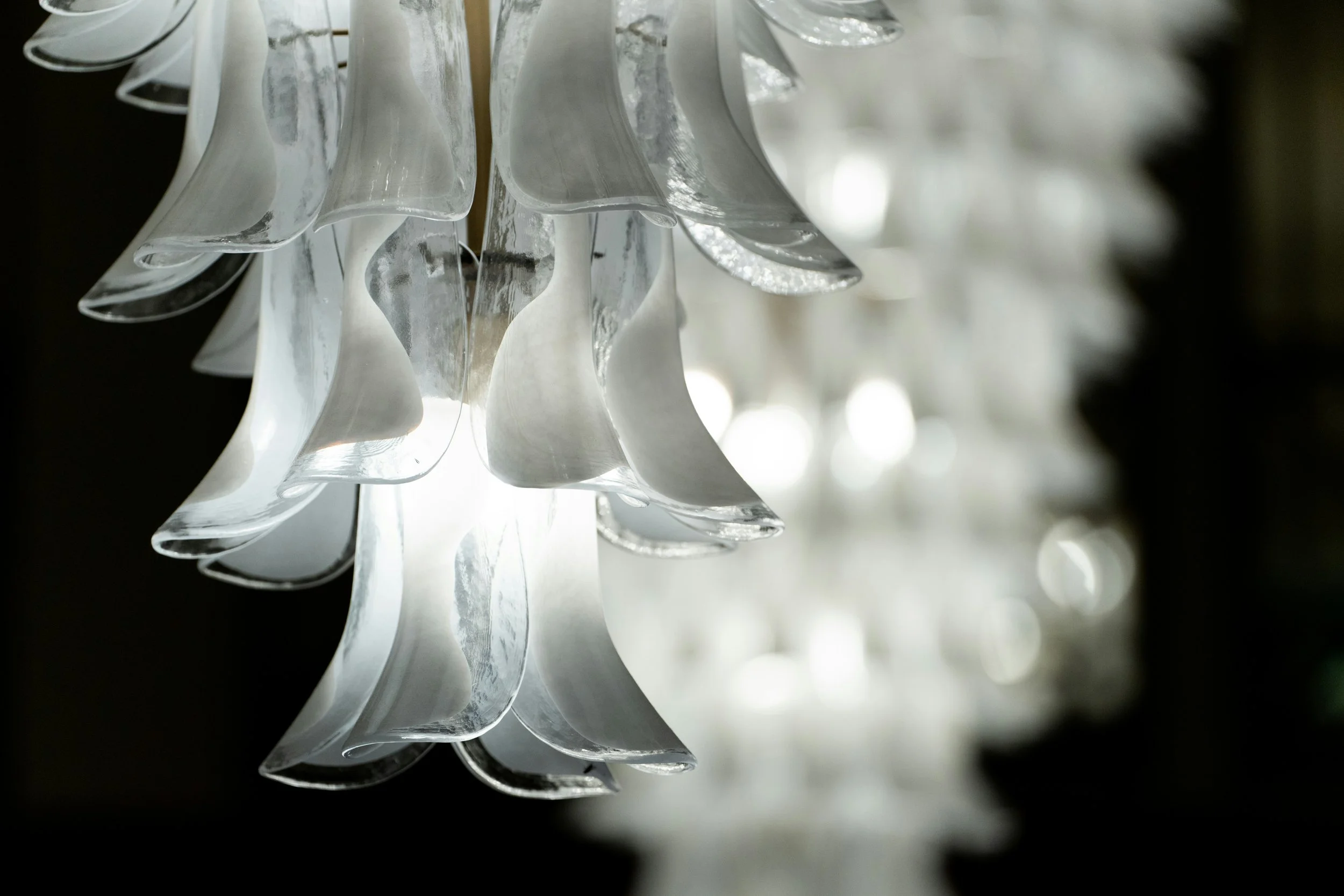 Close-up of a mid-century Murano glass polyhedral chandelier in the dark, dramatic lighting on Italian midcentury lighting design curated by STUDIO21.