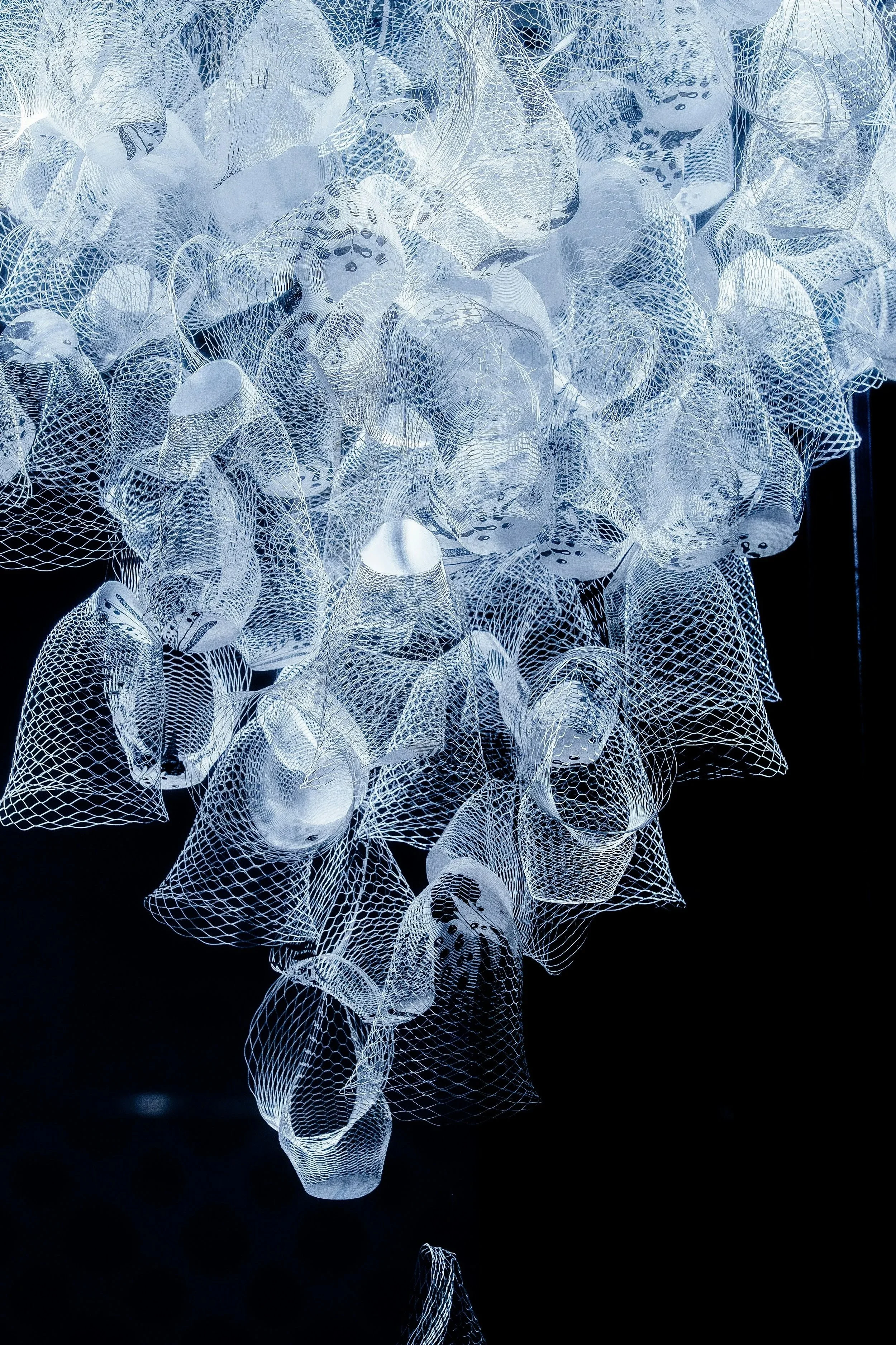 STUDIO21 avant-garde sculptural light installation and custom metal mesh design for luxury contemporary hospitality and residential projects.